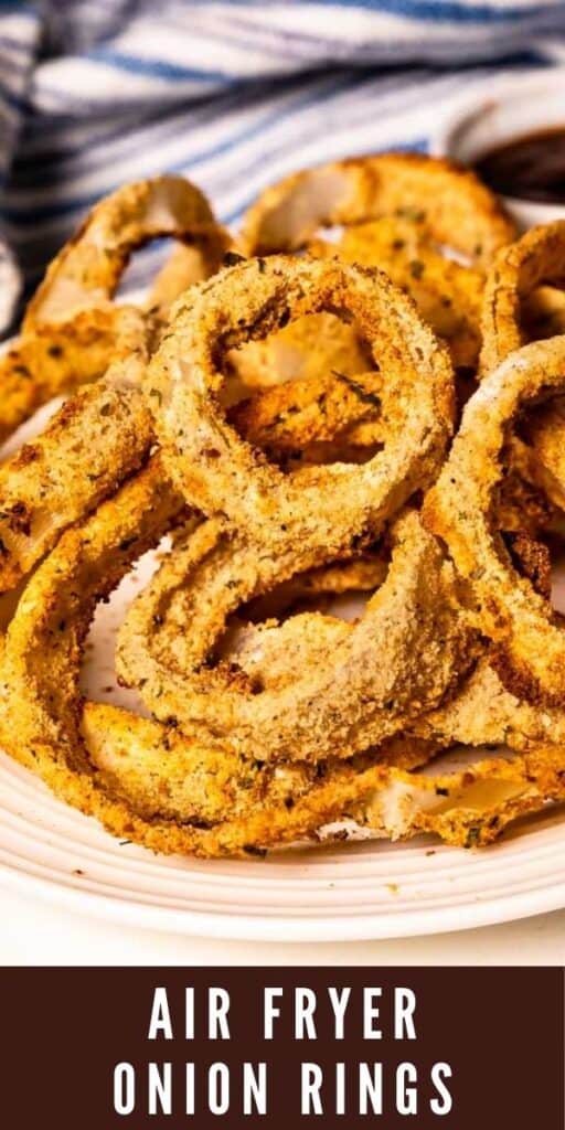 Close up shot of air fryer onion rings on a white plate with recipe title on bottom of photo