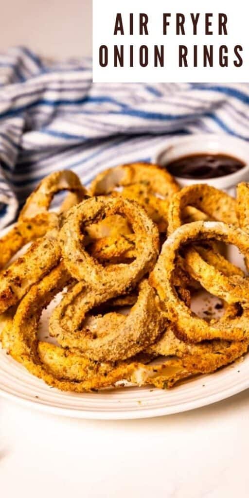 Air fryer onion rings on a white plate with dipping sauce on the side and recipe title in top right corner