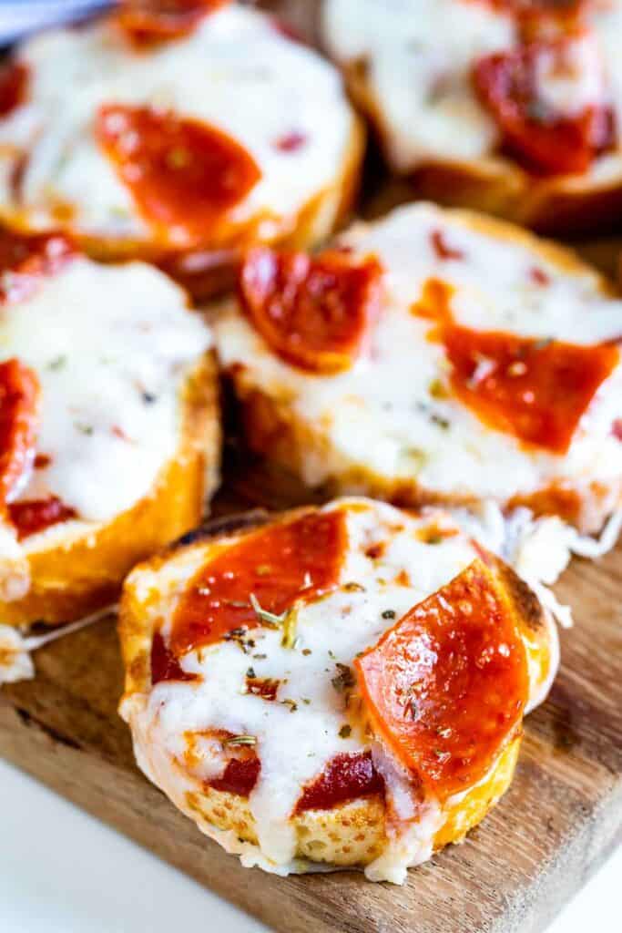 Close up shot of baguette pizza bites with pepperonis on top