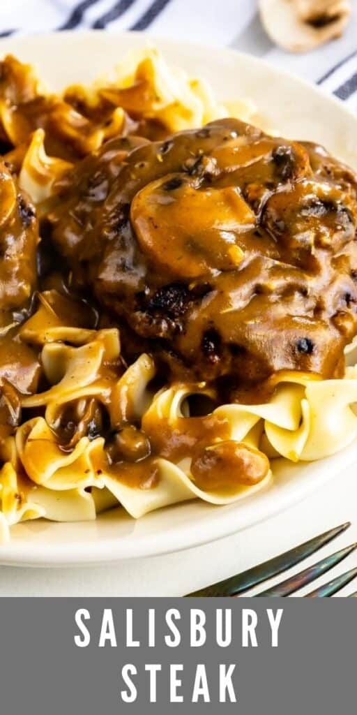 Close up photo of salisbury steak over egg noodles on a white plate with recipe title on bottom of image