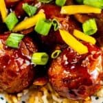 Overhead close up shot of teriyaki meatballs over white rice and recipe title on bottom of image