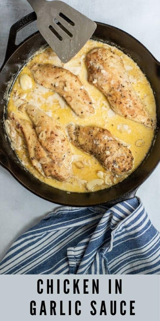 Overhead shot of chicken in garlic sauce in cast iron skillet with blue dish towel on the side and recipe title on bottom of photo
