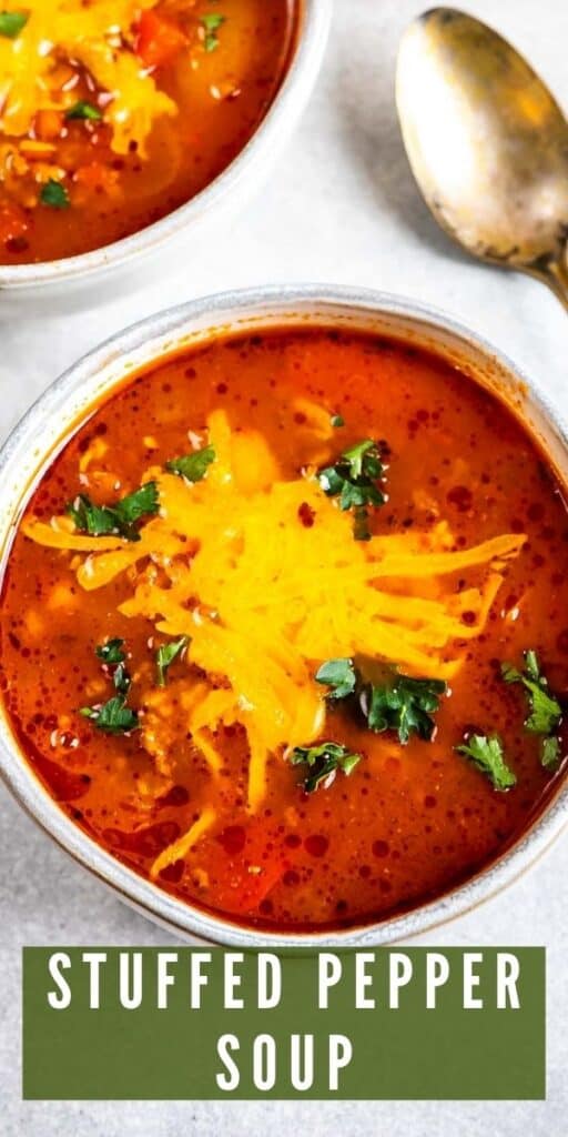 Overhead close up shot of bell pepper soup in a bowl topped with shredded cheddar cheese and recipe title on bottom of photo