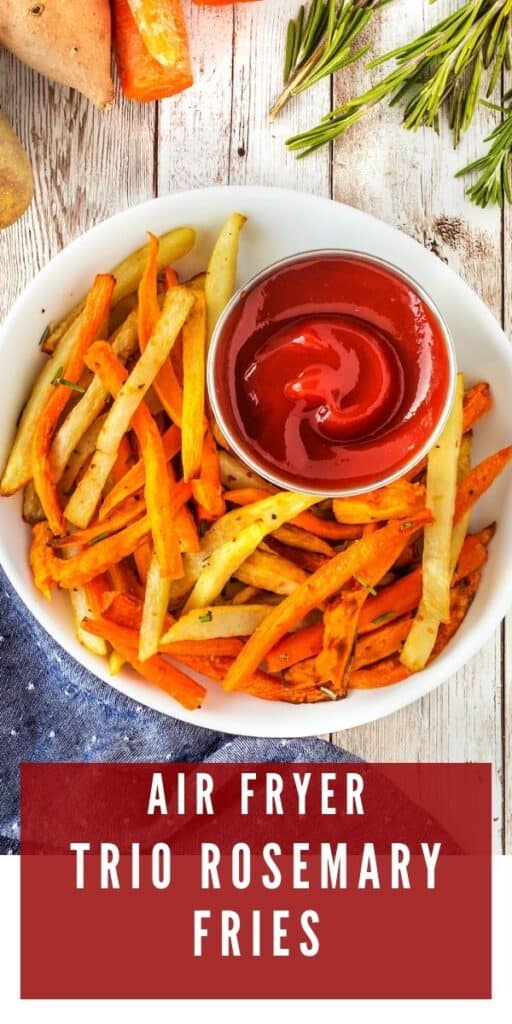 Overhead shot of air fryer fries with ketchup in a white bowl with recipe title on bottom of photo