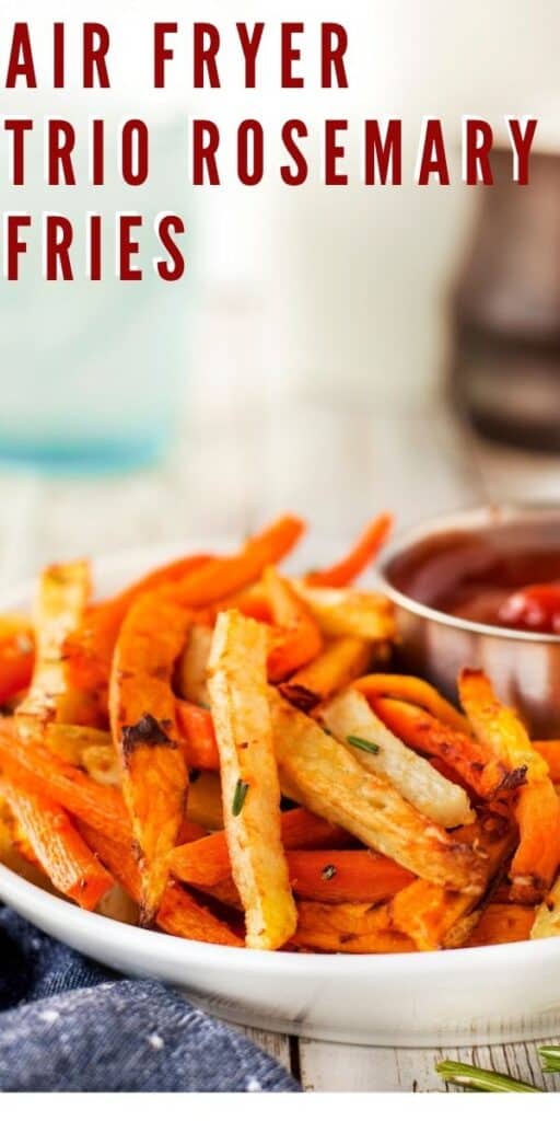Close up of air fryer trio rosemary fries with ketchup and recipe title on top of photo
