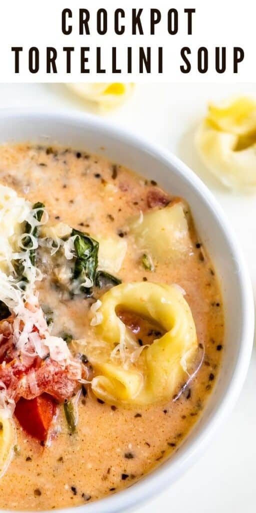 Close up overhead shot of crockpot tortellini soup in a white bowl with recipe title on top of image