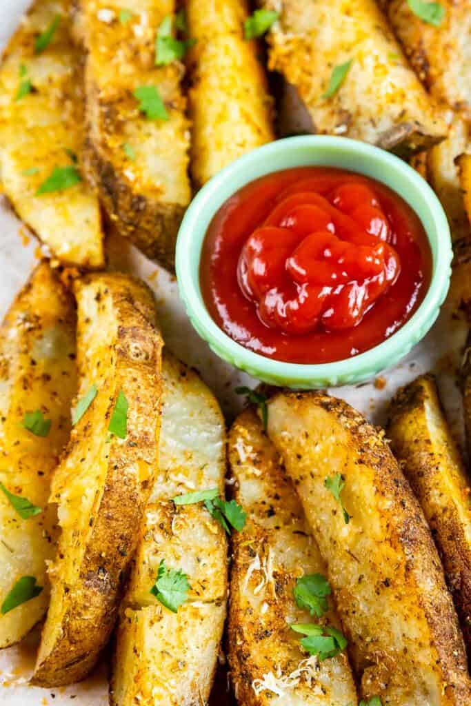 Overhead shot of potato wedges with ketchup