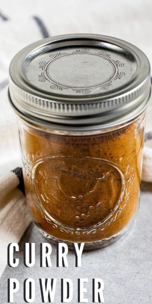 Curry powder in a mason jar with closed lid and recipe title in bottom left hand corner of photo