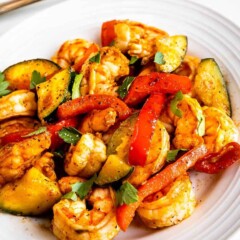 Overhead shot of shrimp and vegetable skillet served on a white plate