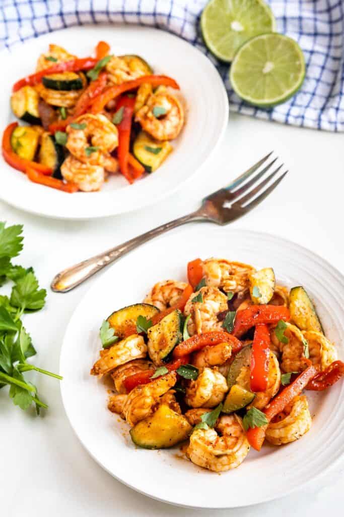 Overhead shot of two plates of shrimp and vegetables skillet dinner