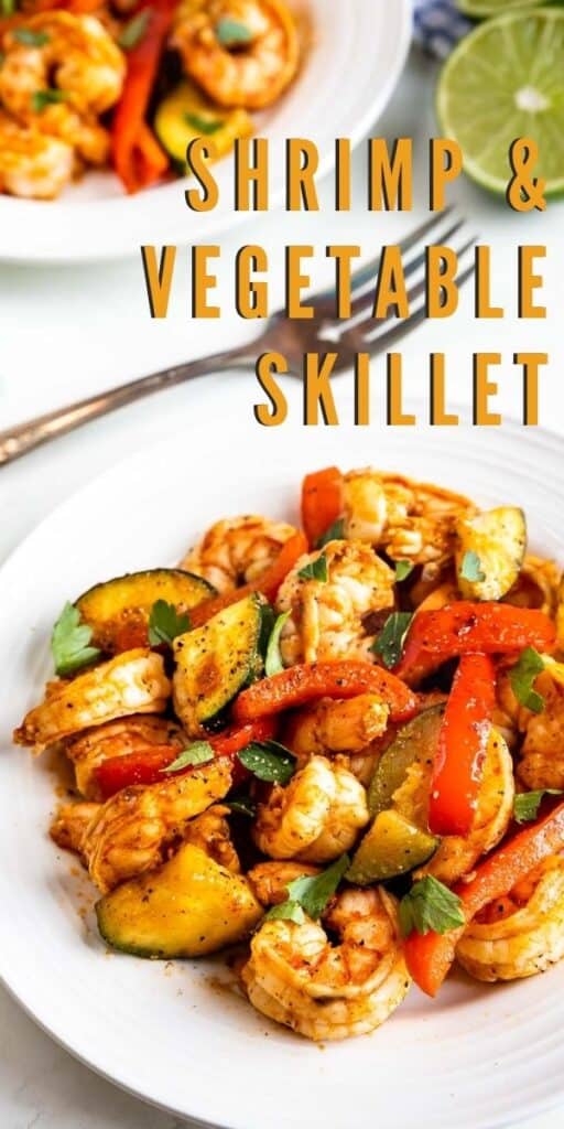 Close up shot of shrimp and vegetable skillet dinner served on a white plate with recipe title in middle of photo