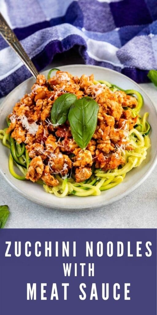 Plate full of zucchini noodles topped with meat sauce and basil with recipe title on bottom of photo
