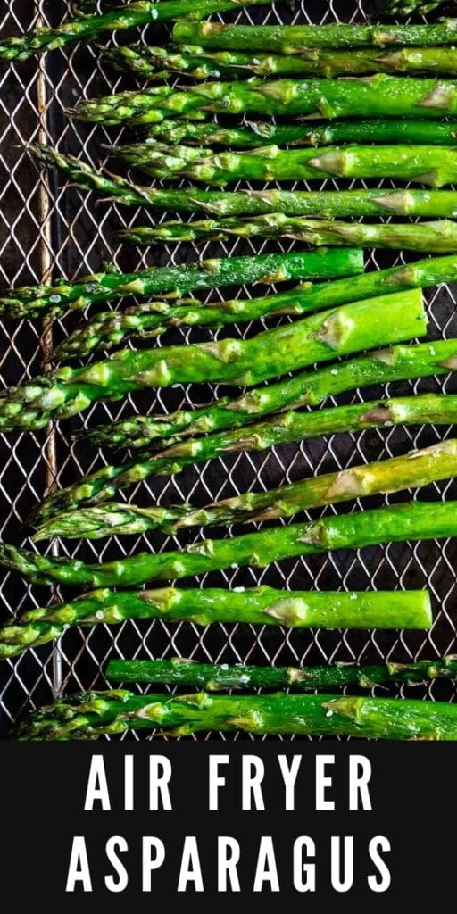 Overhead shot of asparagus on the air fryer rack with recipe title on bottom of photo