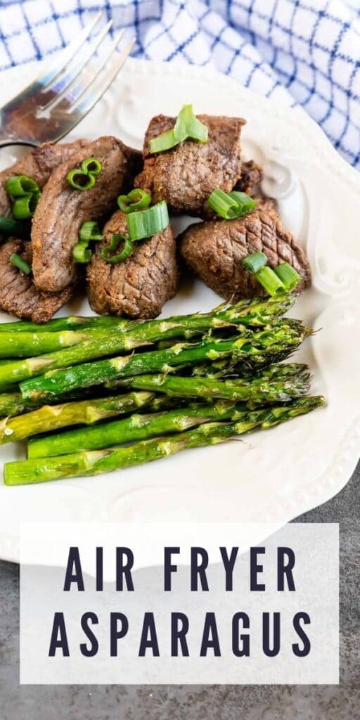 Air fryer asparagus plated next to steak with recipe title on bottom of photo