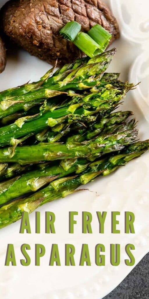Close up overhead shot of air fryer asparagus on a white plate next to steak
