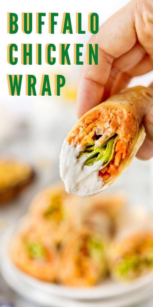 Hand holding a buffalo chicken wrap close to the camera lens with recipe title on top of image