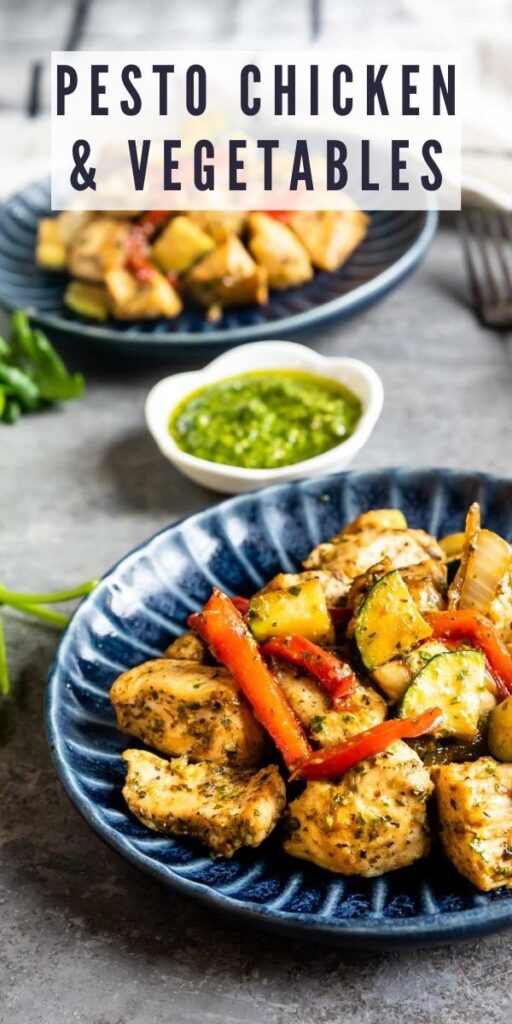Two plates of pesto chicken and vegetables with pesto in the middle and recipe title on top of image