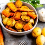 Overhead shot of roasted potatoes and carrots in a bowl