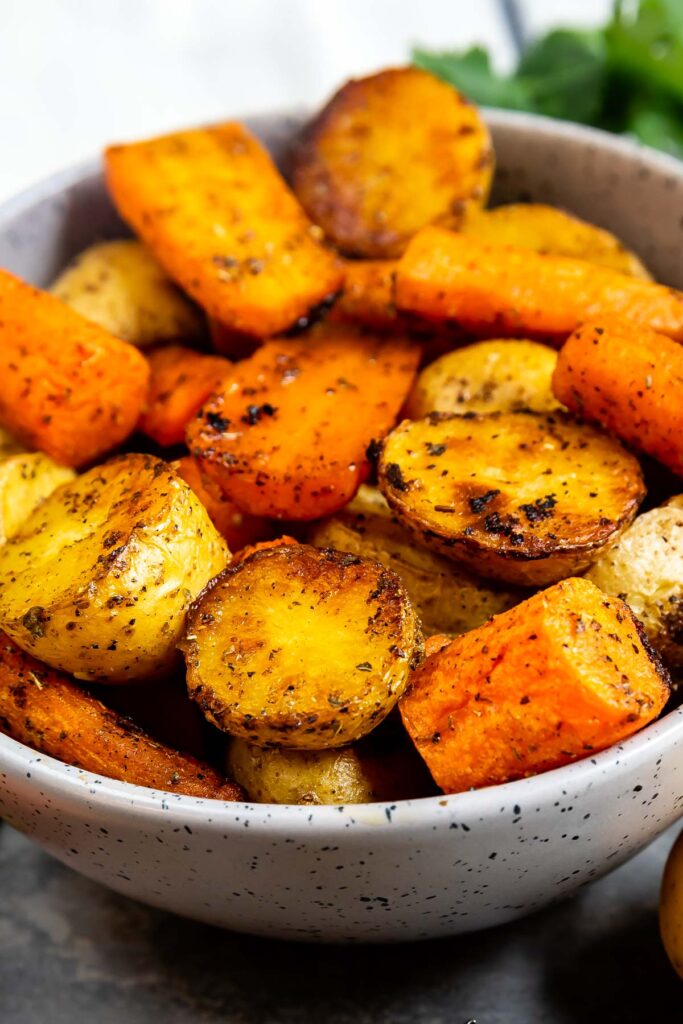 Close up shot of roasted potatoes and carrots