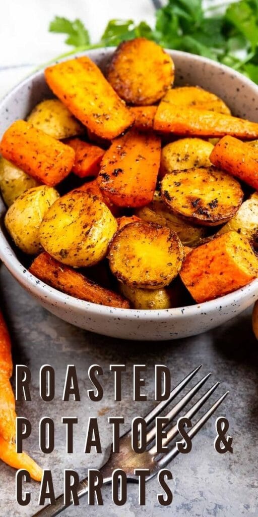 Overhead shot of roasted potatoes and carrots with recipe title on bottom of photo