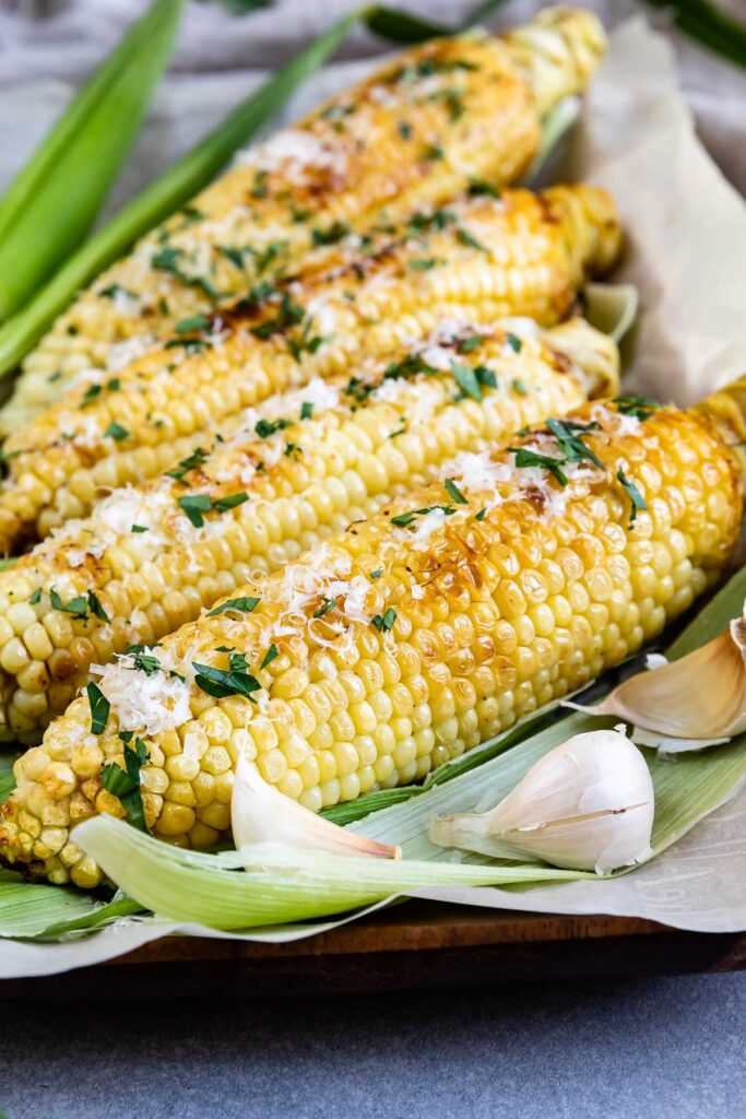 Four ears of garlic butter grilled corn on the cob