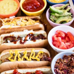 Close up shot of hot dog bar with hot dogs and all the toppings