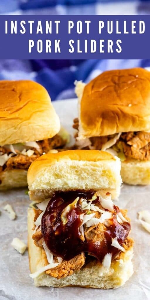 Three instant pot pulled pork sliders on parchment paper and recipe title on top of image