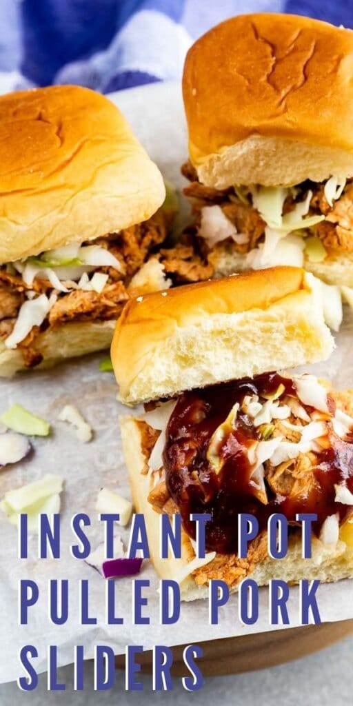 Close up shot of three instant pot pulled pork sliders on parchment paper and recipe title on bottom of image