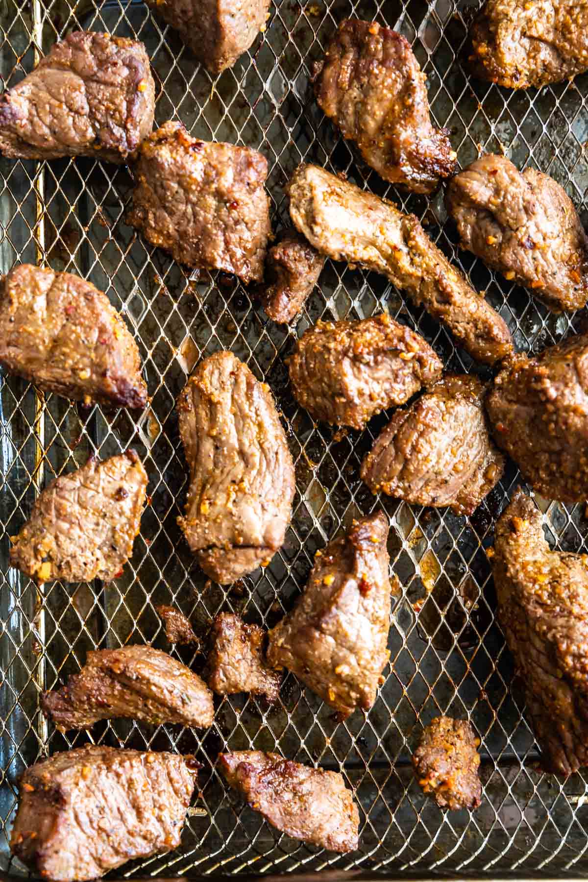 Overhead shot of steak tips on air fryer rack