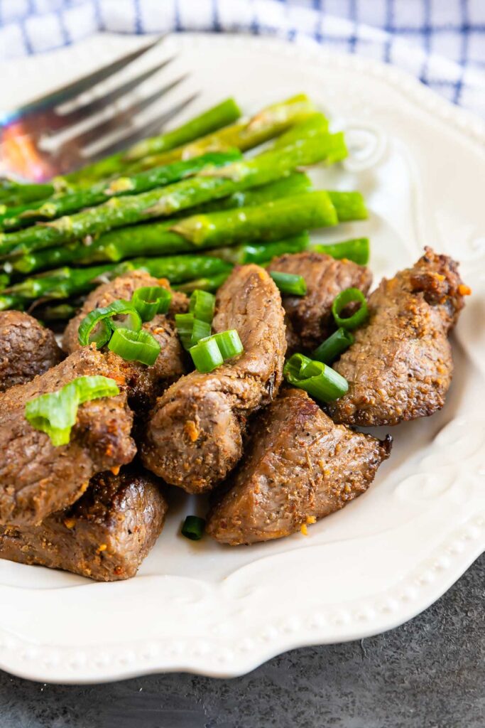 Plate full of air fryer steak tips with asparagus