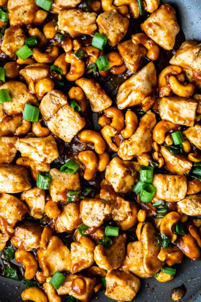 Overhead close up shot of cashew chicken in pan