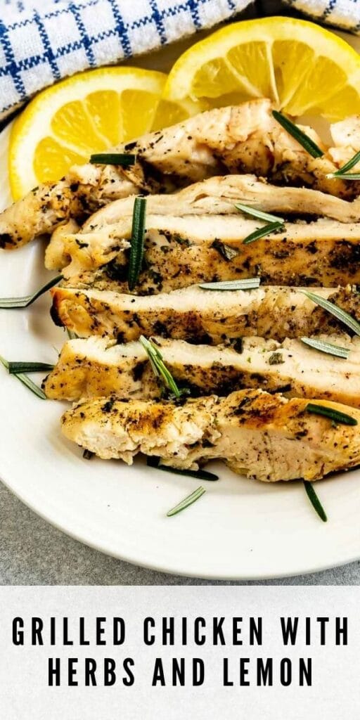 Plate full of grilled chicken slices with herbs and lemon slices with recipe title on bottom of image