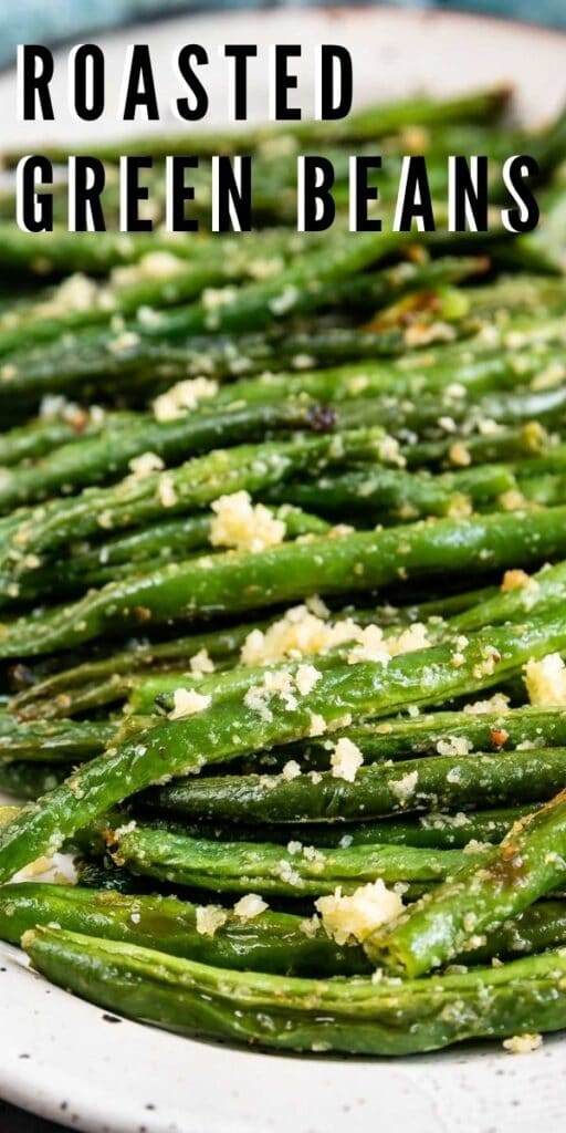 Close up shot of roasted green beans with recipe title on top of image