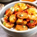 Bowl of spicy shrimp and sausage skillet over white rice