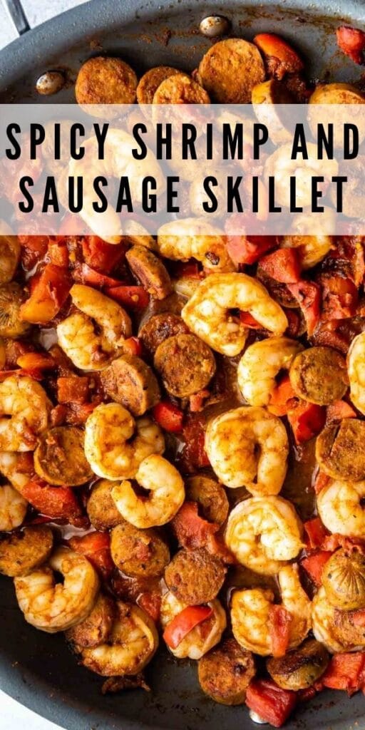 Overhead shot of spicy shrimp and sausage in skillet with recipe title on top of image