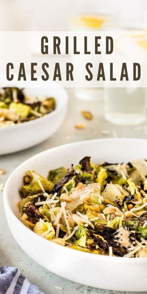 Big bowl of grilled caesar salad with recipe title on top of image