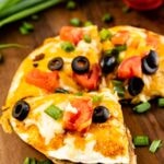 Mexican pizza cut into three triangles on a cutting board