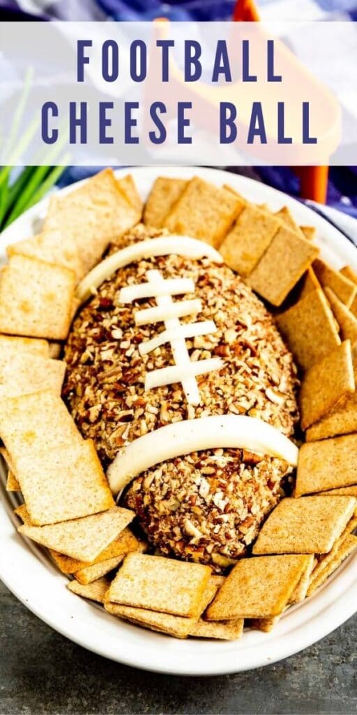 Overhead shot of Football Cheese Ball on a serving plate surrounded by crackers with recipe title on top of image