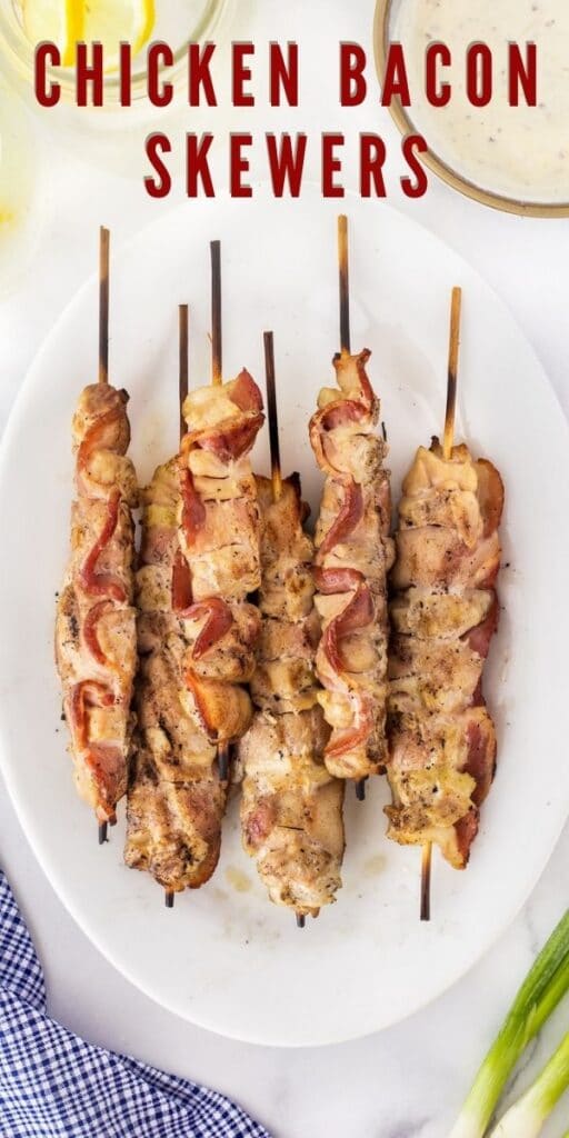 Overhead shot of chicken bacon skewers on a plate with recipe title on top of image
