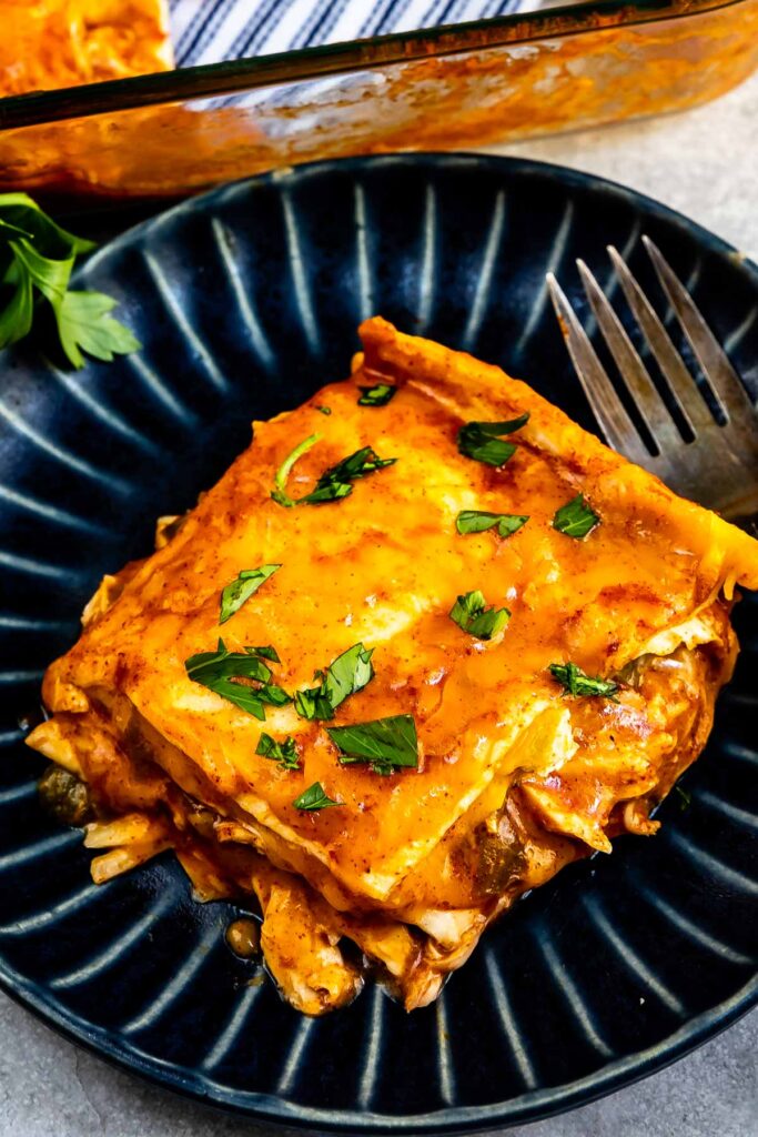 Overhead shot of a slice of enchilada casserole on plate