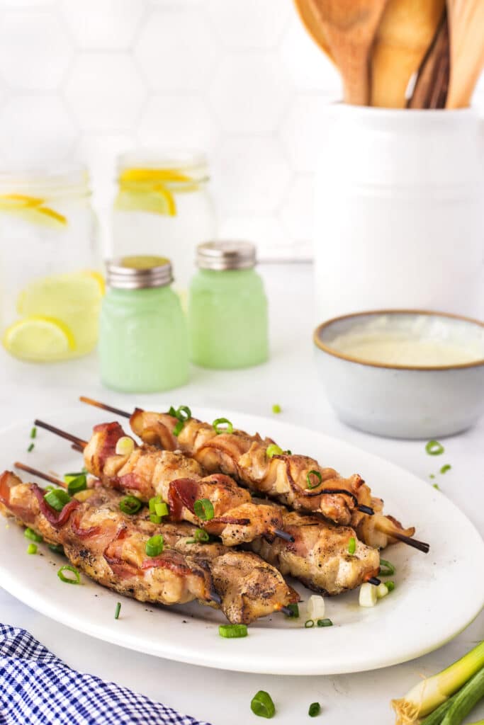 Chicken bacon skewers on a plate ready to be served