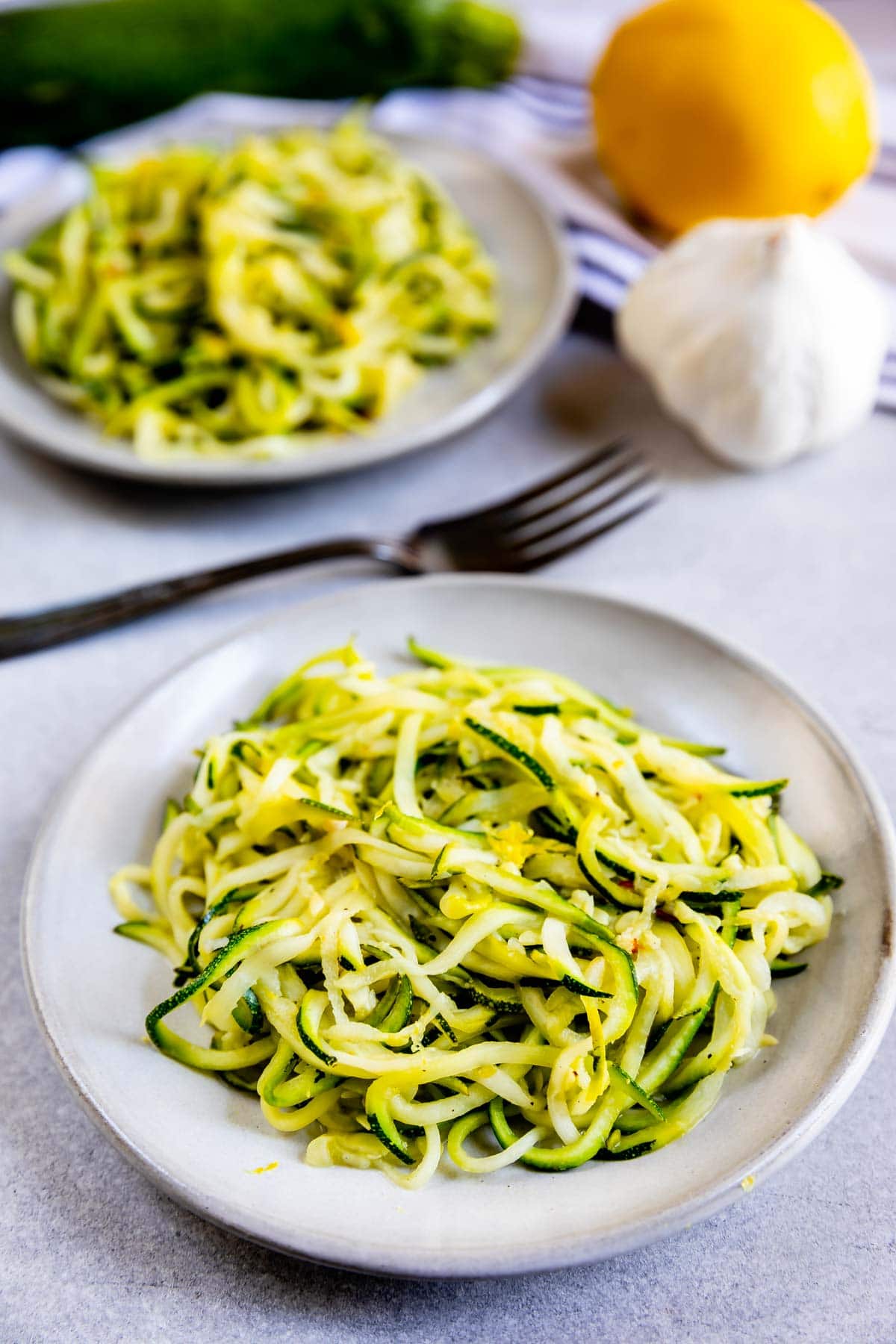 Two plates full of lemon garlic zoodles