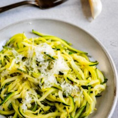 Overhead shot of lemon garlic zoodles with parmesan cheese on top