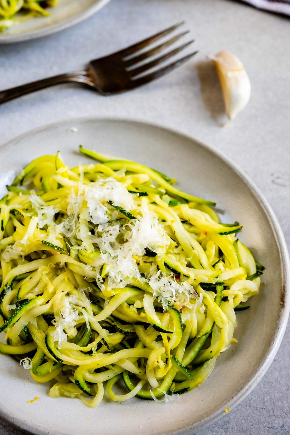 Overhead shot of lemon garlic zoodles with parmesan cheese on top