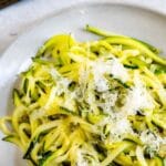 Overhead shot of lemon garlic zoodles with recipe title on top of photo