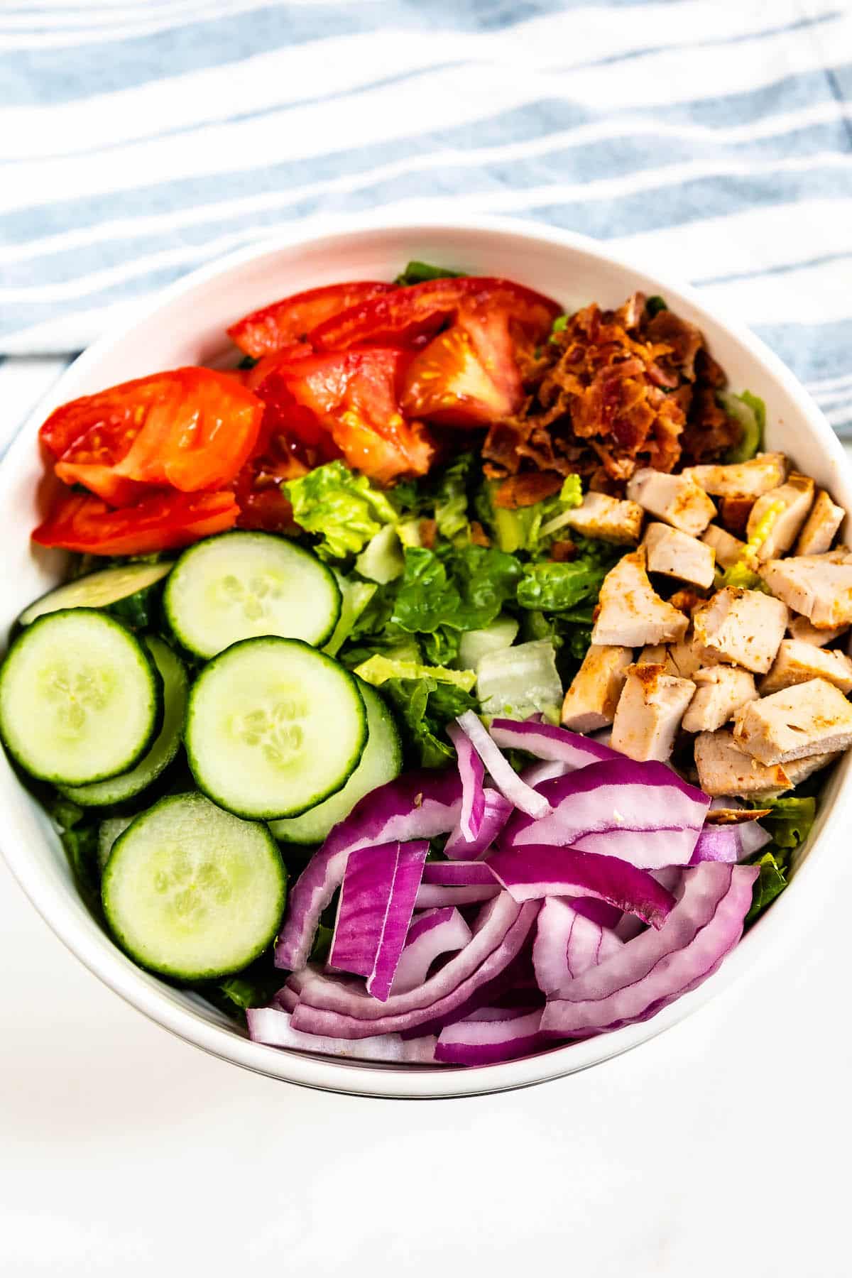 overhead shot of salad ingredients in bowl.