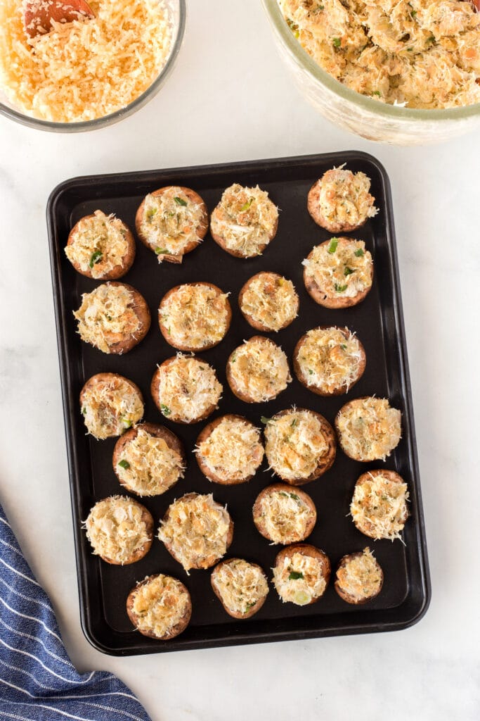Overhead shot of crab stuffed mushrooms on baking sheet before being baked