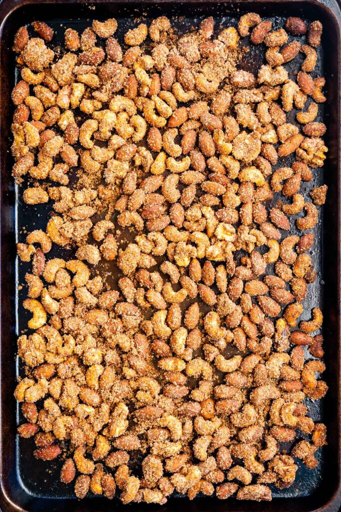 Overhead shot of sweet and spicy nuts on a sheet pan