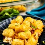 Close up shot of tater tot and chili casserole on a blue plate