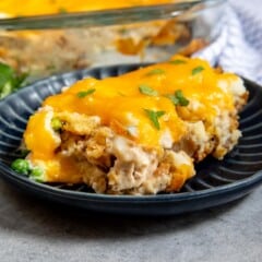 Close up side shot of thanksgiving casserole on a plate with full casserole in background